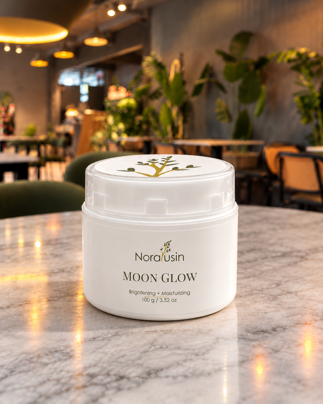 Moon Glow night cream jar on a marble café table